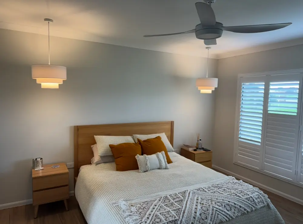 Ceiling fan and pendant lights installed in a bedroom