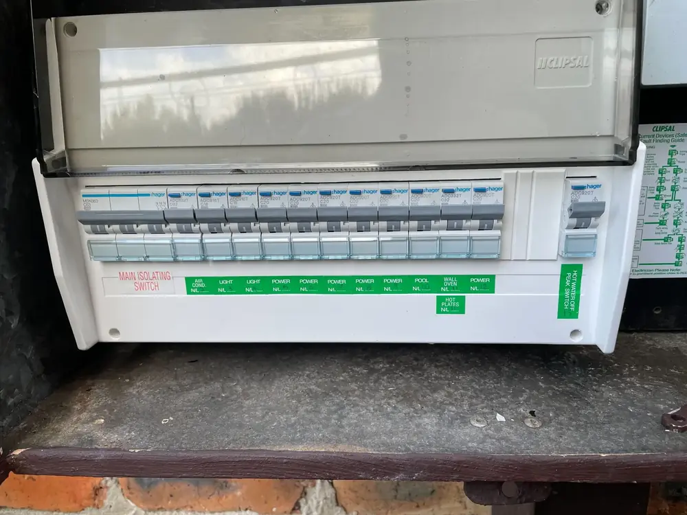 Rows of labelled circuit breakers inside a domestic electrical switchboard