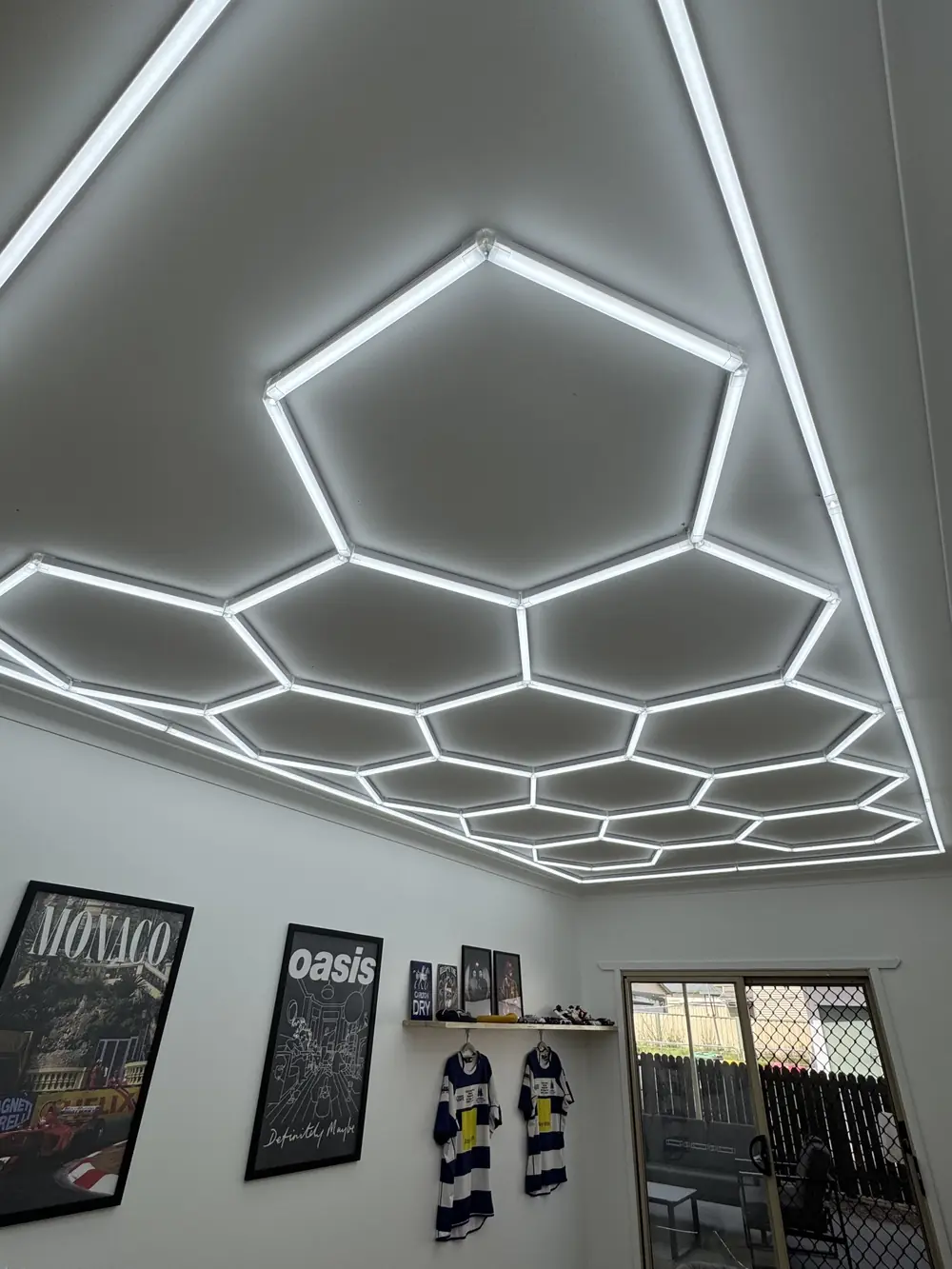 Illuminated hexagonal ceiling lights in a room