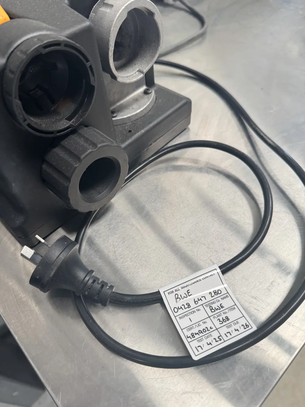 Electrical outlet assembly and coiled power lead with an attached test and tag label